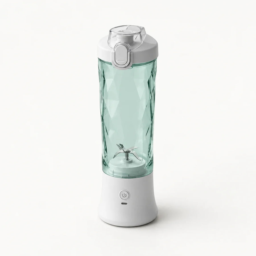 Blender portable 600 ml blanc avec gobelet vert d'eau à facettes et couvercle gris clair à clapet, sur fond blanc cassé