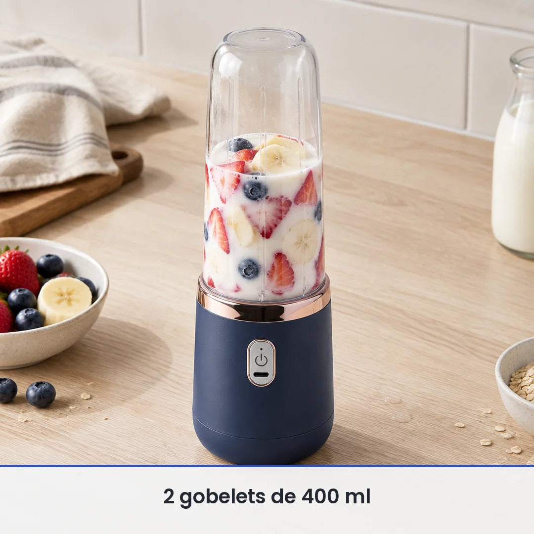 Gobelet de 400 ml du blender bleu marine rempli aux deux tiers de fraises, myrtilles, banane et lait, sur un comptoir