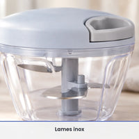 Gros plan sur les lames inox fixées sur l'axe gris du hachoir manuel à ficelle, vues à travers le bol transparent fermé