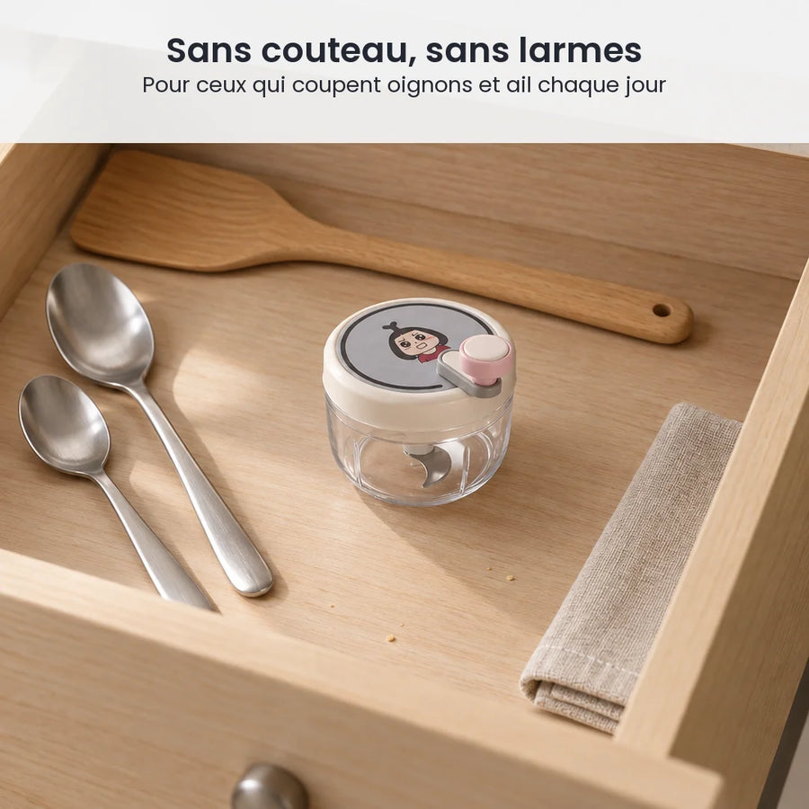 Hachoir manuel rotatif 200 ml à couvercle beige rosé rangé dans un tiroir de cuisine en bois clair